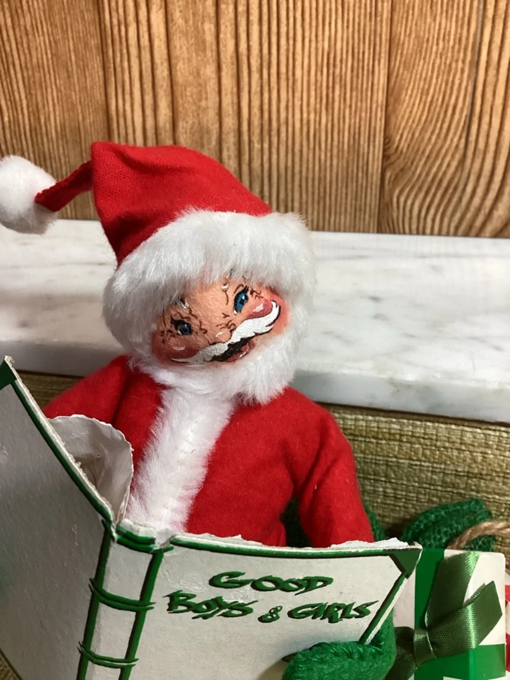 Vintage Anna Lee Red Santa Doll with White Trim sitting of his sack of toys